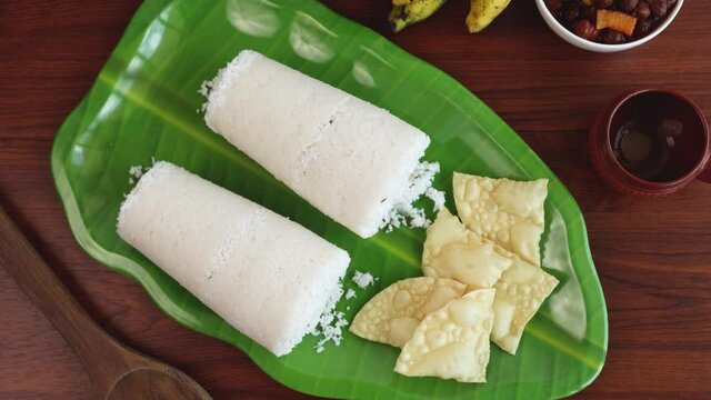 Rice Puttu white Pittu , Kadala Chickpea curry , milk tea , popular South Indian breakfast steamed rice cake 4K slow motion video footage Kerala Tamil Nadu India Sri Lanka. rice flour grated coconut  