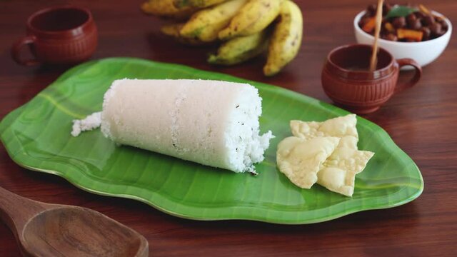 Rice Puttu white Pittu , Kadala Chickpea curry , milk tea , popular South Indian breakfast steamed rice cake 4K slow motion video footage Kerala Tamil Nadu India Sri Lanka. rice flour grated coconut  