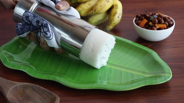 Rice Puttu white Pittu , Kadala Chickpea curry , milk tea , popular South Indian breakfast steamed rice cake 4K slow motion video footage Kerala Tamil Nadu India Sri Lanka. rice flour grated coconut  