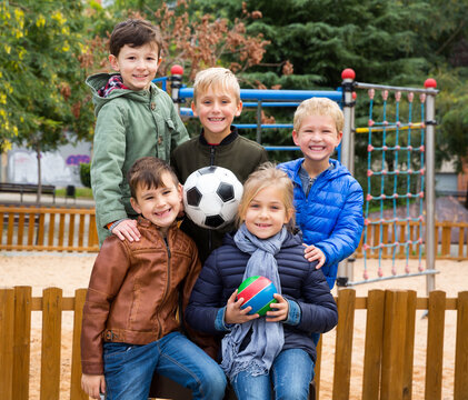 Group portrait of children with soccer ball in the park. High quality photo