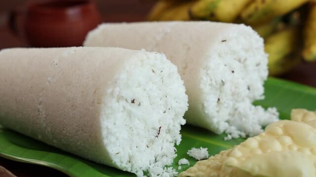 Rice Puttu white Pittu , Kadala Chickpea curry , milk tea , popular South Indian breakfast steamed rice cake 4K slow motion video footage Kerala Tamil Nadu India Sri Lanka. rice flour grated coconut  