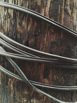 Close up of electrical wire around telephone pole