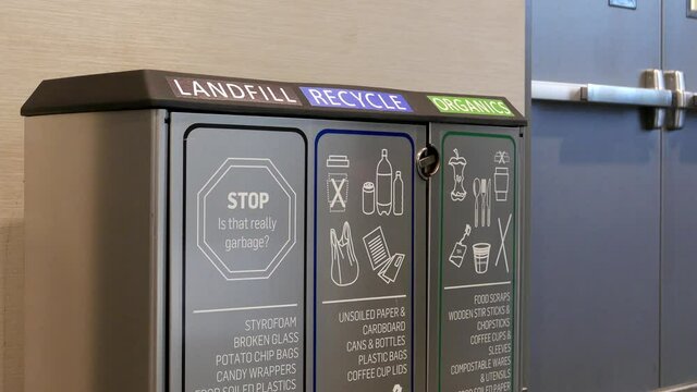 Woman throwing a plastic bottle to the recycle bin inside Pan pacific Vancouver hotel
