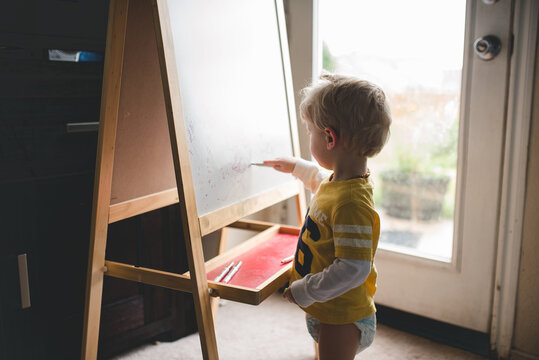 boy drawing on art board