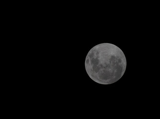 the moon a black cloak illuminating the earth
