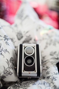 Twin lens reflex on bed with rainbow