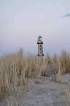 Lighthouse in Warnemuende behing dunes at dusk