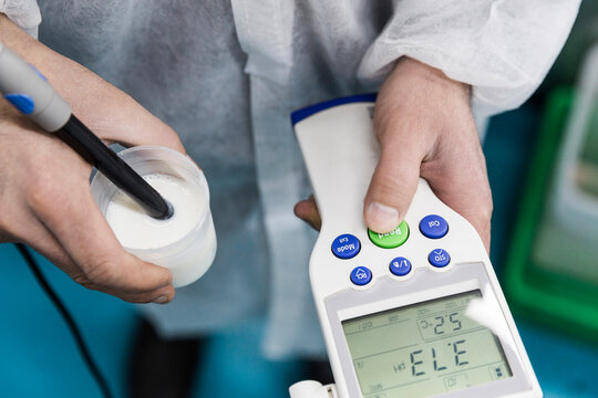 Hand performing a PH test with electronic measuring device