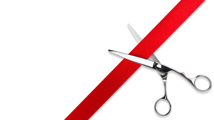 Scissors Grand opening. Top view of scissors cutting red silk ribbon against white isolated background with copy space. Silver stainless metal scissors or shears.