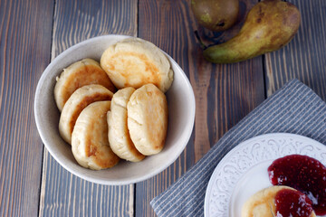 Delicious lush homemade cheesecakes on a wooden table