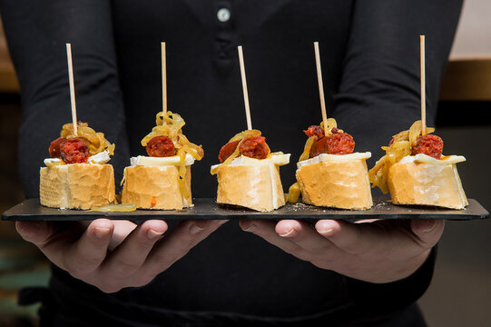 Waiter holding some spanish tapas