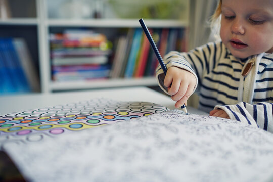 Little toddler girl colouring in