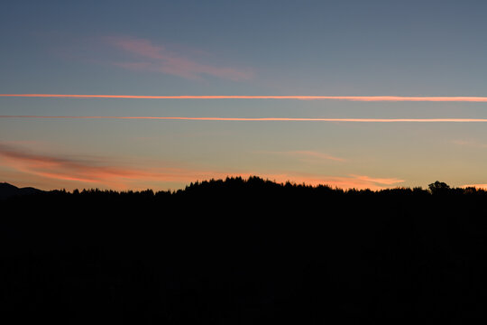 Contrails in the sky before the sun rises