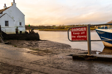 Danger Keep off the slipway sign at Kirkcudbright Harbour on a winters afternoon