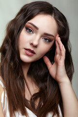 Fototapeta premium Beauty portrait of young woman. Brunette girl with evening female makeup and black dess