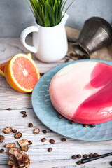 Red and white cake with orange filling. Nearby on a black table are ingredients oranges, nuts. Rustic style
