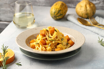 Linguine pasta with pumpkin creamy sauce, rosemary leaves and roasted pumpkin cubes, garnished with pumpkin seeds