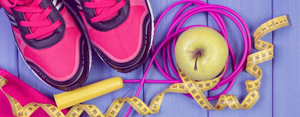 Sport shoes, accessories for fitness and fresh apple. Healthy sporty lifestyles