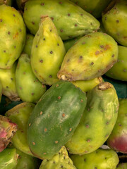 Green prickly pears at a supermarket display.