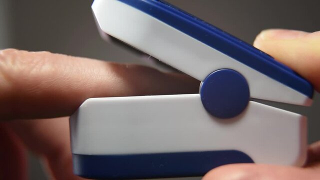 The process of measuring the level of oxygen in the blood. A modern pulse oximeter device in action