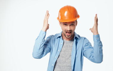 architect in orange helmet and unbuttoned shirt gesturing with hands cropped view white background