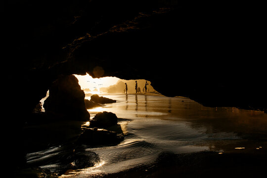 People's silhouette on the beach at sunset