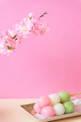 Fototapeta na wymiar Cherry Blossoms and three Colour Dango Dumplings. cherry blossom viewing, hinamatsuri, a new start, spring, Japan. 桜と三色団子。お花見、雛祭り、新生活、春、日本など