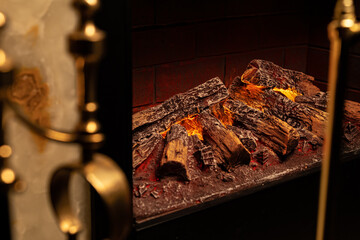 Close up of a fireplace with burning wood logs inside