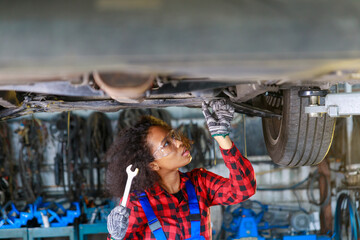 Fototapeta na wymiar African Female auto mechanic working at the repair shop.