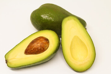 Avocado fresh green half on white.