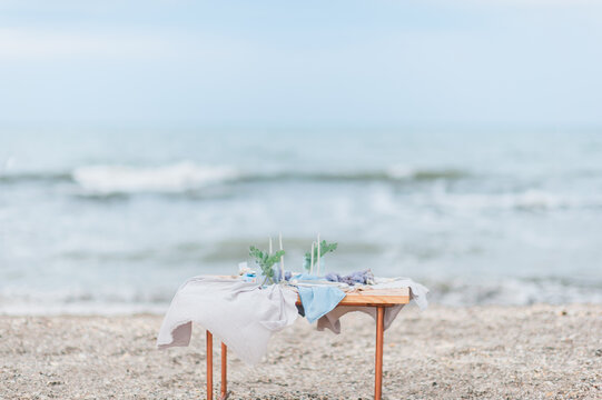 Table setup on the beach on summertime; Table for two on the beach