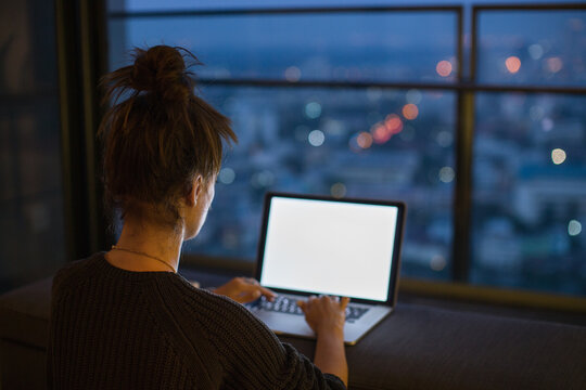 Woman working from her laptop at night