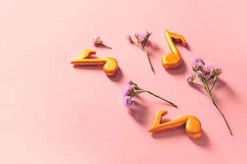 Music notes and flowers on color background
