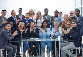 a group of businessmen applaud each other, emphasizing their suc