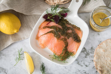 Gravlax Graved Lachs, ein roh gebeizter Fisch mit Dill auf Platte mit Hovmästarsås Senf Soße,...