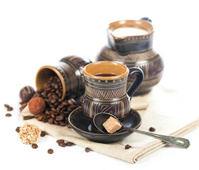 old black pottery, coffee beans, candy and a cup of drink