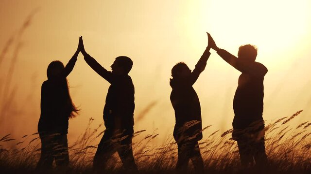 teamwork. team of tourists greet each other rejoice in success silhouette. business teamwork a travel tourism concept. group of people clap each other symbol team of victory success
