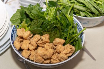 Homemade fried tofu and Chinese salad ingredients for a Chinese vegan fondu soup