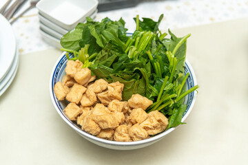 Homemade fried tofu and Chinese salad ingredients for a Chinese vegan fondu soup