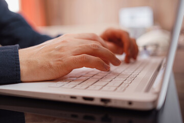 Businessman or student using laptop at home