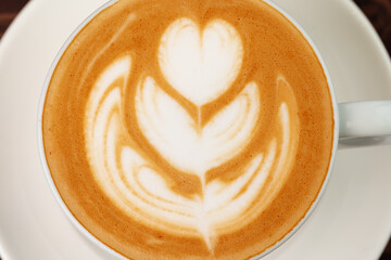 Cup of hot coffee latte on table