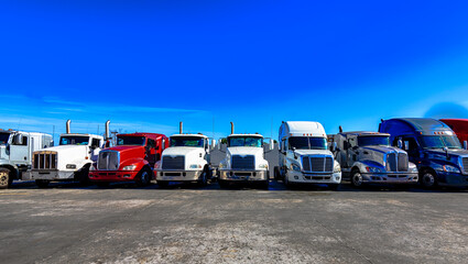 HDR image of Semi trucks lined up on a parking lot.
