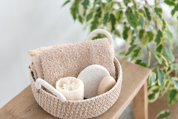 jute basket with body care products - organic soap, sponge, loofah and towel