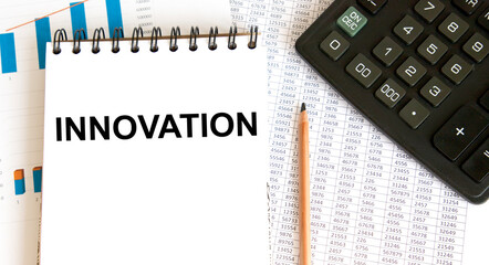 In the notebook, the text is INNOVATION, pencil, calculator, graphs and reports.