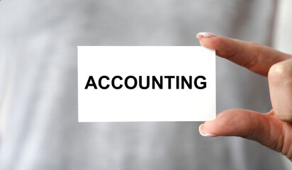 A girl holds a business card with a tectonics.