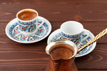 Traditional turkish coffee in oriental dishware close up