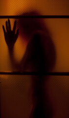 the dark silhouette of a girl in the doorway - 412442186