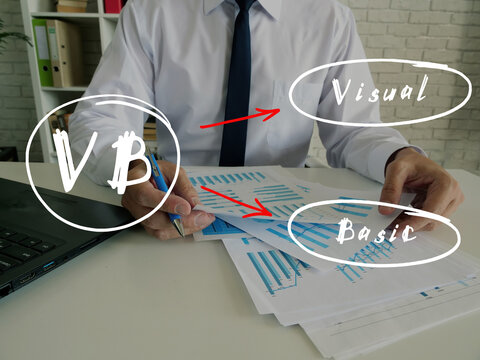 Conceptual photo about VB Visual Basic with written text. Young Business Man Signing Documents on background.