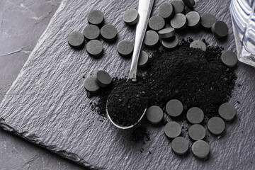 activated carbon on a dark stone background