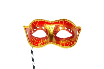 Red mask party or carnival Venetian mask with handle isolated on white background	